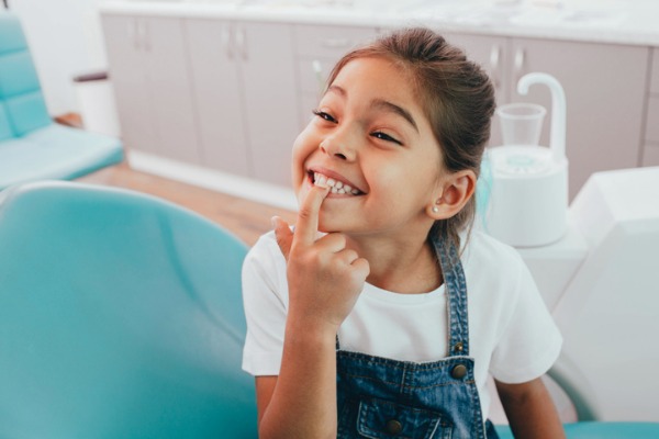 mixed-race-little-patient-showing-her-perfect-toothy-smile-while-picture-id1165526820.jpg