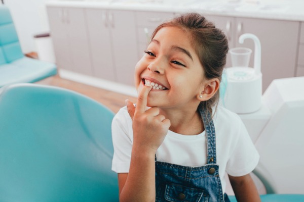 mixed-race-little-patient-showing-her-perfect-toothy-smile-while-picture-id1165526820.jpg